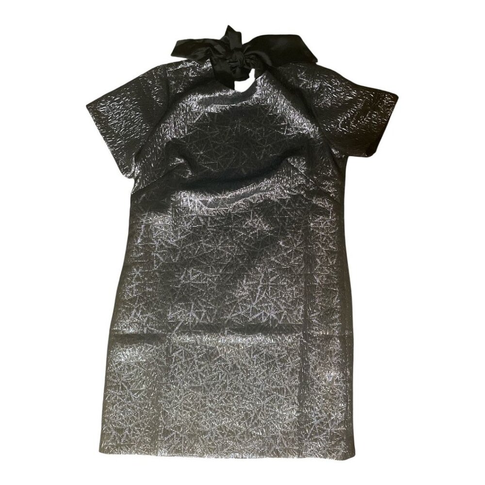 A dark-colored short dress with a shiny pattern and a high neck with a bow.